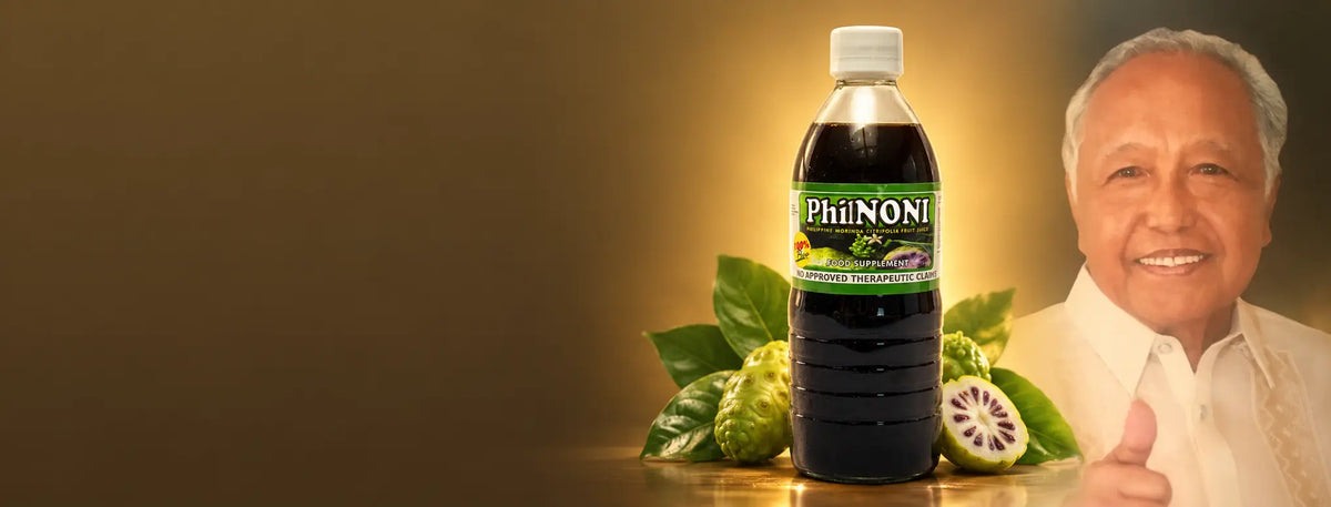 A bottle of PhilNoni with Morinda Citrifolia fruit in front of Dr. Tito Contado, founder of PhilNoni