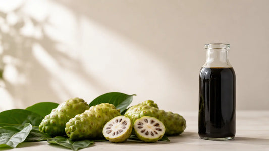 Fresh noni fruit (Morinda citrifolia) beside a bottle of PhilNONI juice